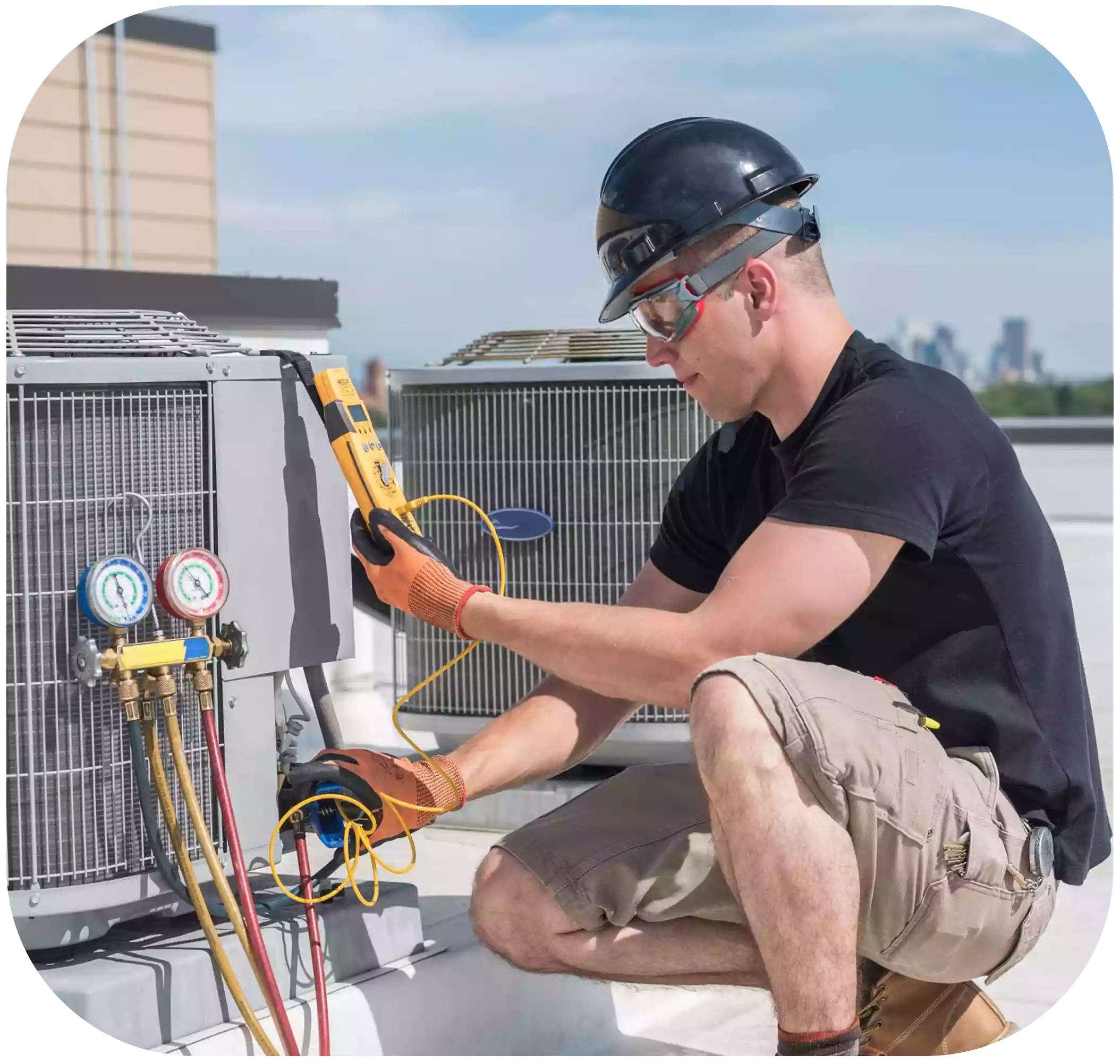 A technician uses measurement equipment to fill gas tanks in air conditioners.